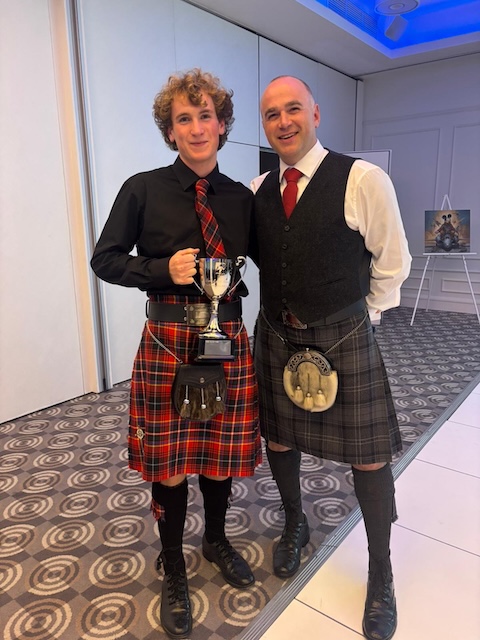 Callum Innes with coach Gordon and the Sam Lynch Award Trophy